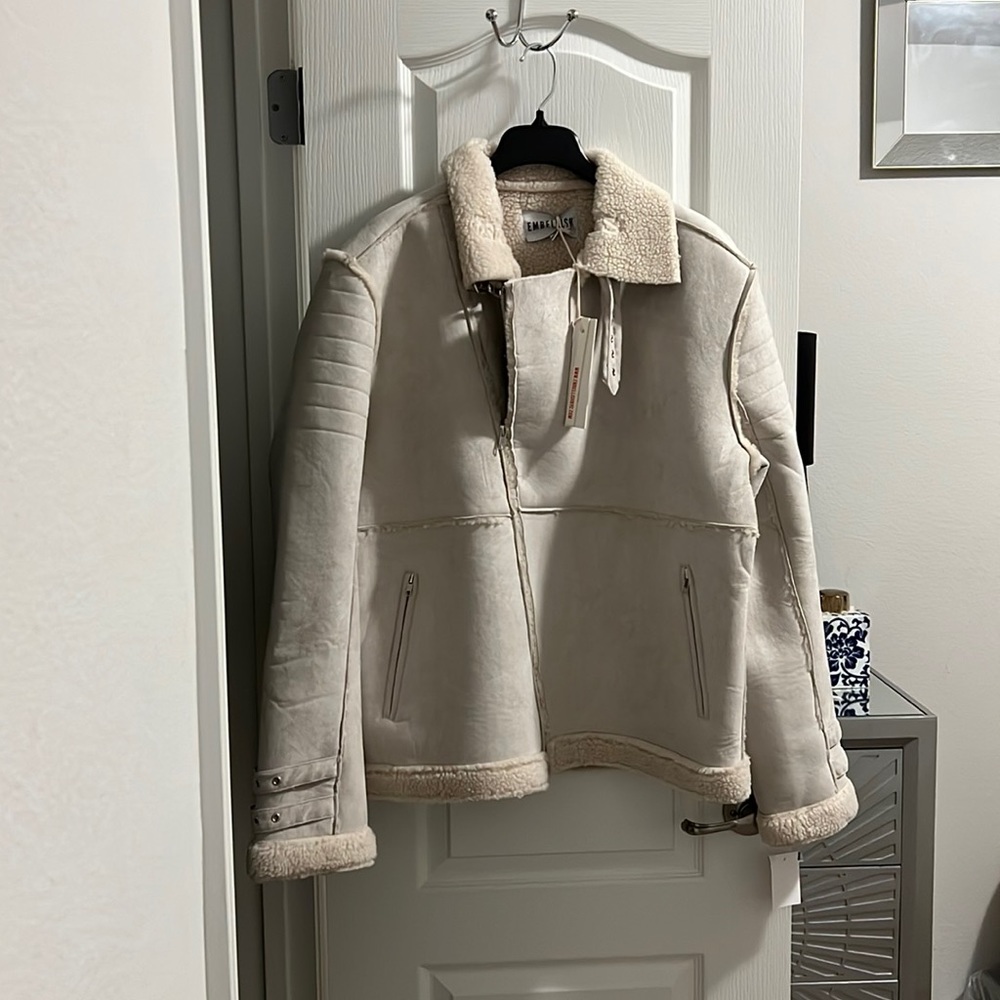 Faux shearling. Never worn. Stylish and warm for those extra cold days.